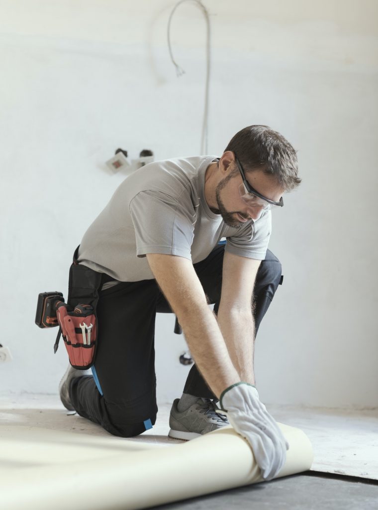Contractor removing an old linoleum flooring